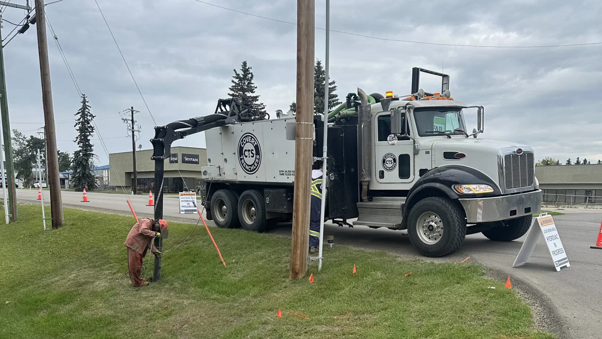 Hydrovac truck working at a curb